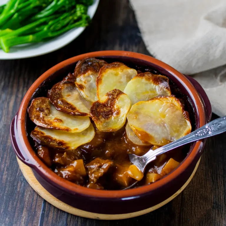 Lancashire Hotpot - lamb stew with sliced potatoes in terracotta dish