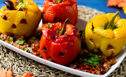 Red & yellow peppers carved like jack-o-lantern pumpkins, stuffed with chilli con carne